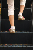 a child climbing up steps on a playground 