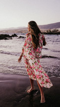 Woman in floral dress by the beach