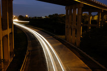 Lights along a highway under an overpass.