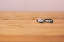 Wedding rings on a wooden table.