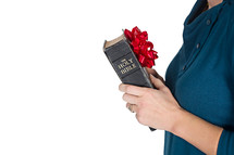 woman holding a Bible with a red bow