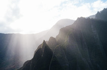 sunbeams on a rugged cliffs on a mountainous island landscape 