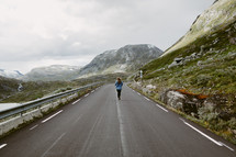 a woman jogging on a road 