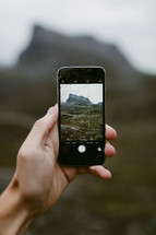 taking a picture of a mountain peak in Norway with a smartphone 