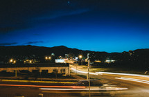 City streets and mountains at night.