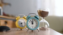 Time passing - alarm clocks and hour glass