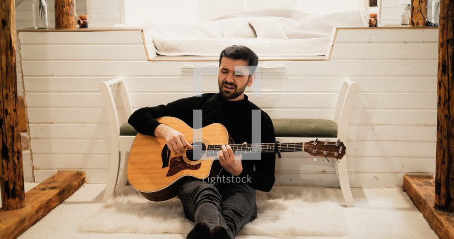 a man playing a guitar 
