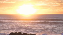 Golden sunrise over ocean in New Zealand slow motion
