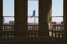 view of the Texas flag from the state capitol building in Austin 