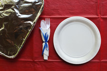 paper plate place setting and foil covered casserole 