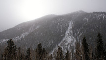 falling snow near a mountain 