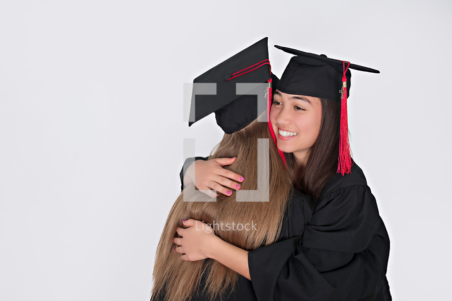 graduates hugging 