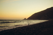tide washing onto a rocky shore at dusk 