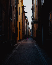 man walking in a narrow alley 