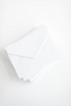 stacked white envelopes 