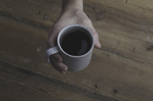 hand around a coffee mug 