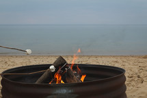 roasting marshmallows on a beach 