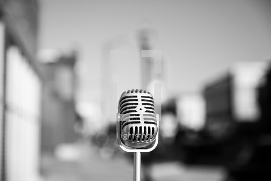 Retro microphone in the middle of a city.  