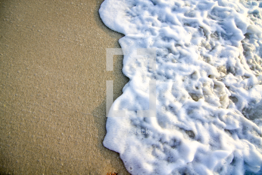 sea foam on sand on a beach 