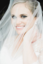 bride's face behind a veil 