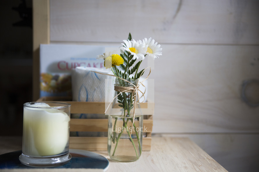 daisies in a vase and candle 
