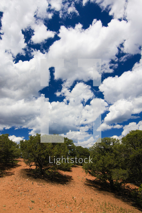 blue sky and clouds over a dry terrain 
