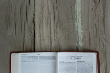 a Bible opened to 1 John 