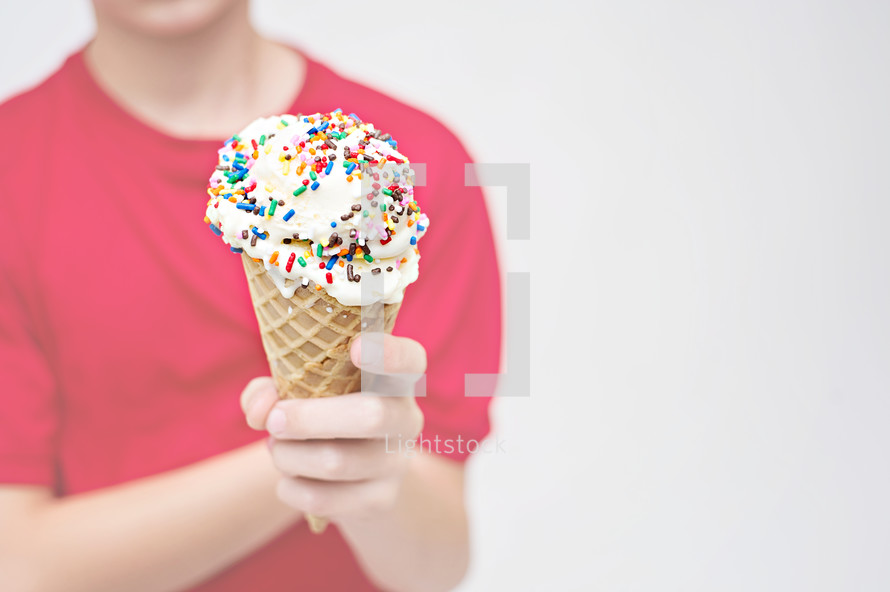 child holding an ice cream cone 