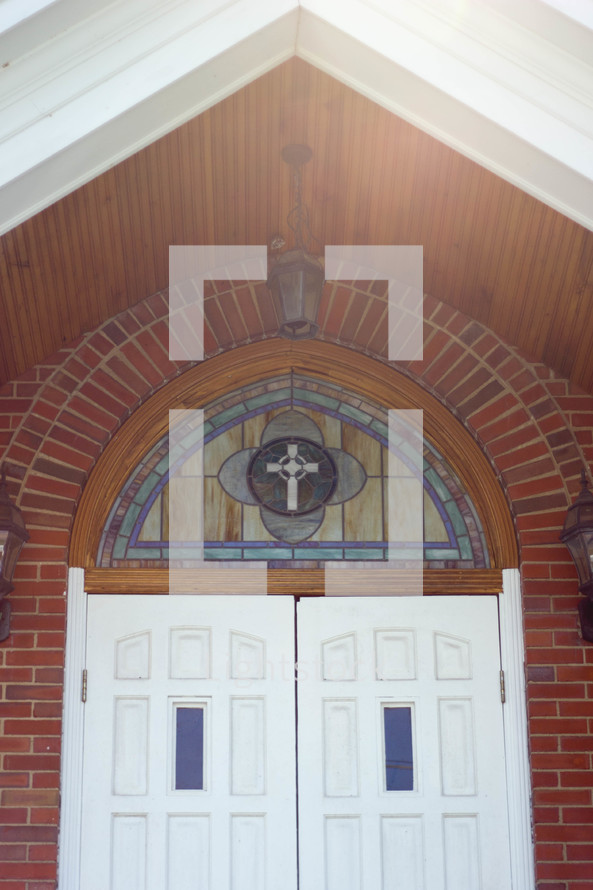 stained glass window above church doors 