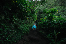 a woman hiking through the jungle 