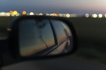 rear view mirror and bokeh lights at night 