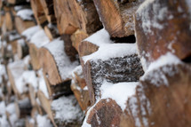 snow on wood pile 
