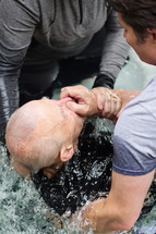 men being baptized in water 