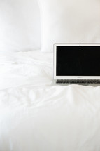 laptop on a bed 