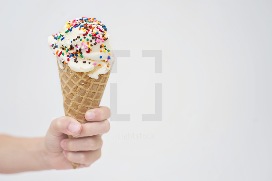 hand holding a waffle cone 
