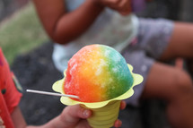 child eating a snow cone 