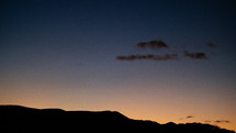silhouettes of mountains at sunset 