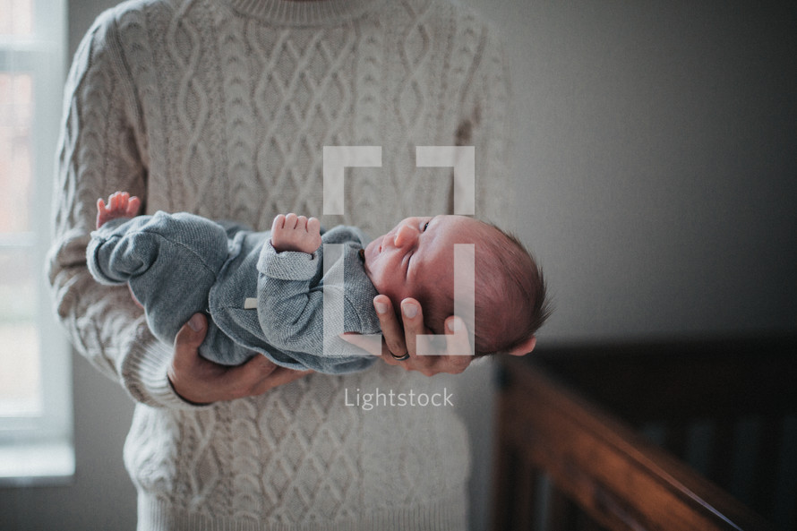 a father cradling a newborn 