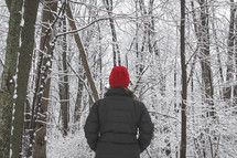 woman standing outdoors in a forest in winter 