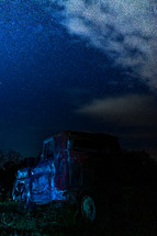 old rusty truck under a night sky 