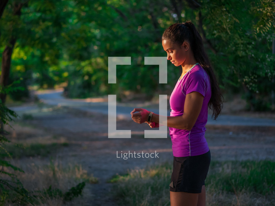 Portrait of young pretty sporty athletic woman  on summer park nature background. Lady before run workout.