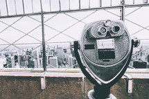 viewfinder scope on a city building rooftop 