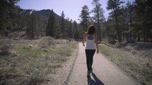 a woman walking on a trail 