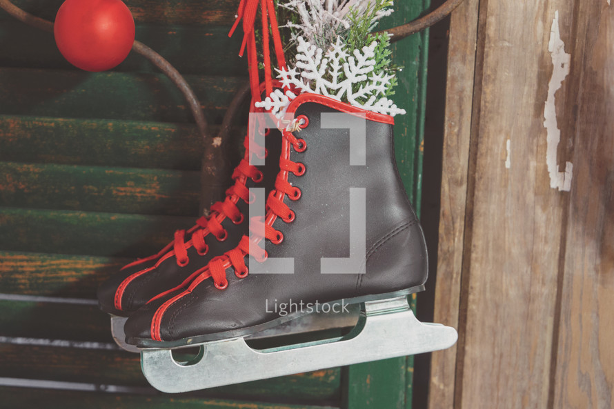 Christmas decoration stock photo featuring ice skates for winter sports that would make a nice social media post or slide presentation background or bulletin cover.
