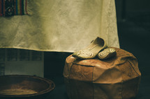 wooden bowl and shoes on a stool 