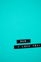 A label reading, "Dad, I love you," on a turquoise background.