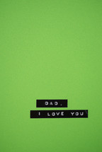 A label reading, "Dad, I love you," on a green background.