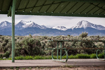 picnic table under a cover and view of mountains 