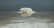 Tracking shot of salt deposits on the banks of the Dead Sea in israel