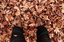 boots standing in fall leaves 